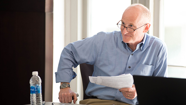 Professor David Lassman listening to a student