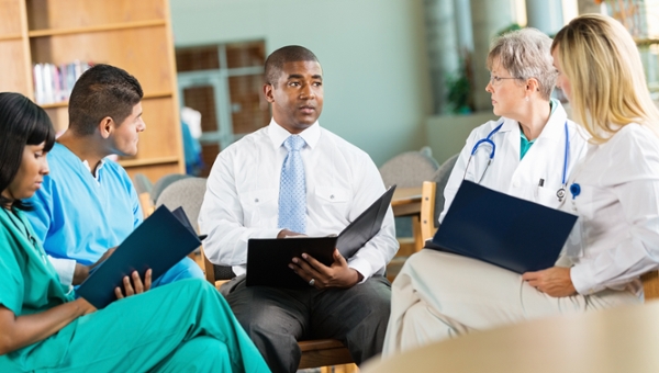 Executive discussing business strategy with a group of physicians