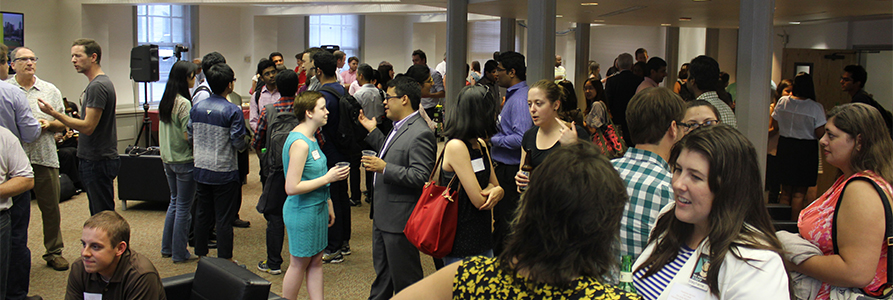 Large event with many people standing around in groups talking