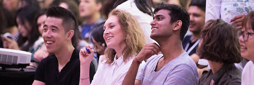 Students at Orientation, listening to a speaker