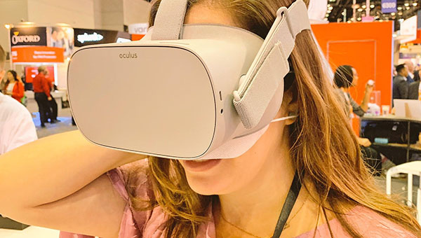 Student wearing a VR headset at a healthcare conference