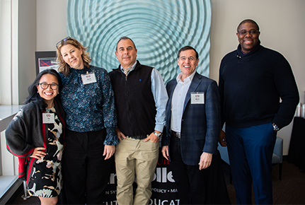 A group of women and men enjoy an executive education event.