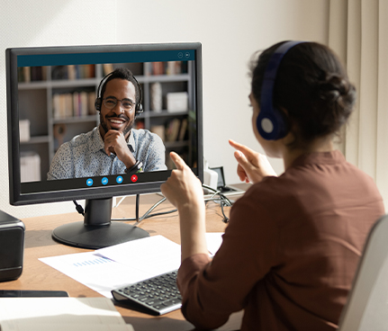 A woman and a man chat on a video call.