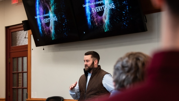 Jimmy Priestas, Heinz alumni, presents at the front of the classroom.