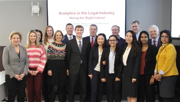 Heinz College students gather with their clients and faculty after presenting their capstone project .