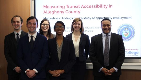 Heinz College students gather after presenting their capstone project on transit accessibility.