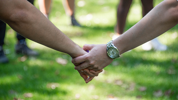 Students holding hands at orientation event