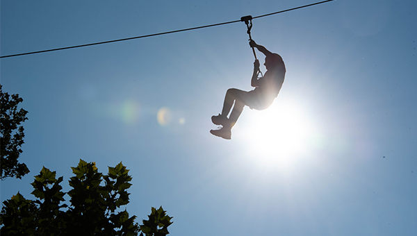 Student on zip line at orientation event