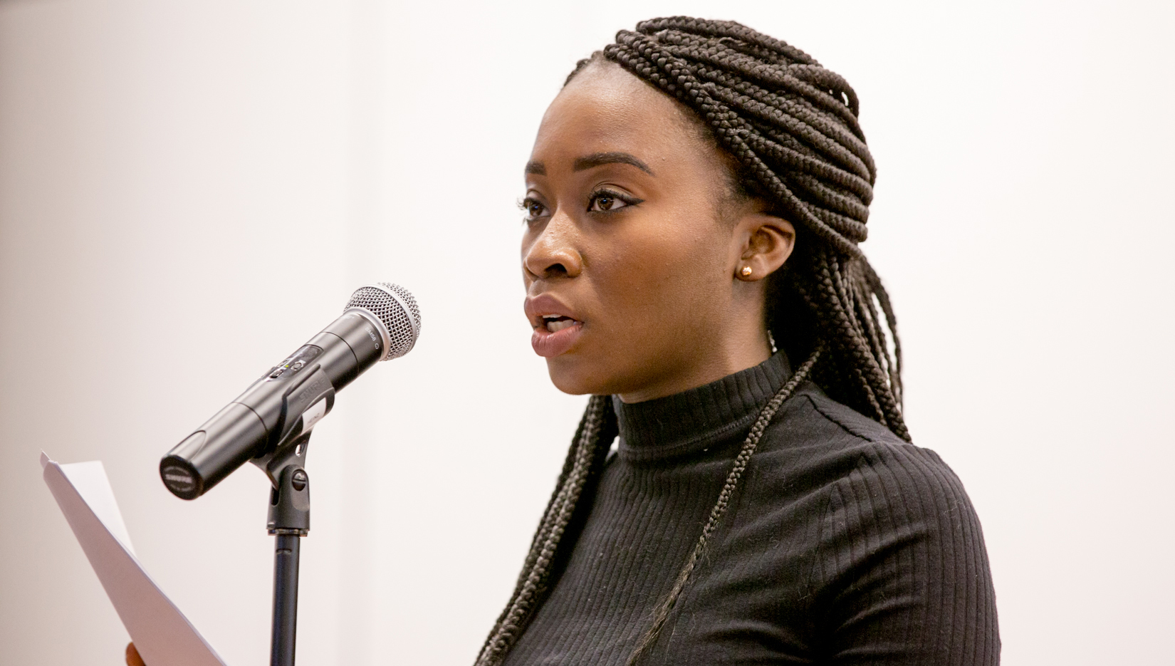 Heinz College student reading poetry in Hamburg Hall