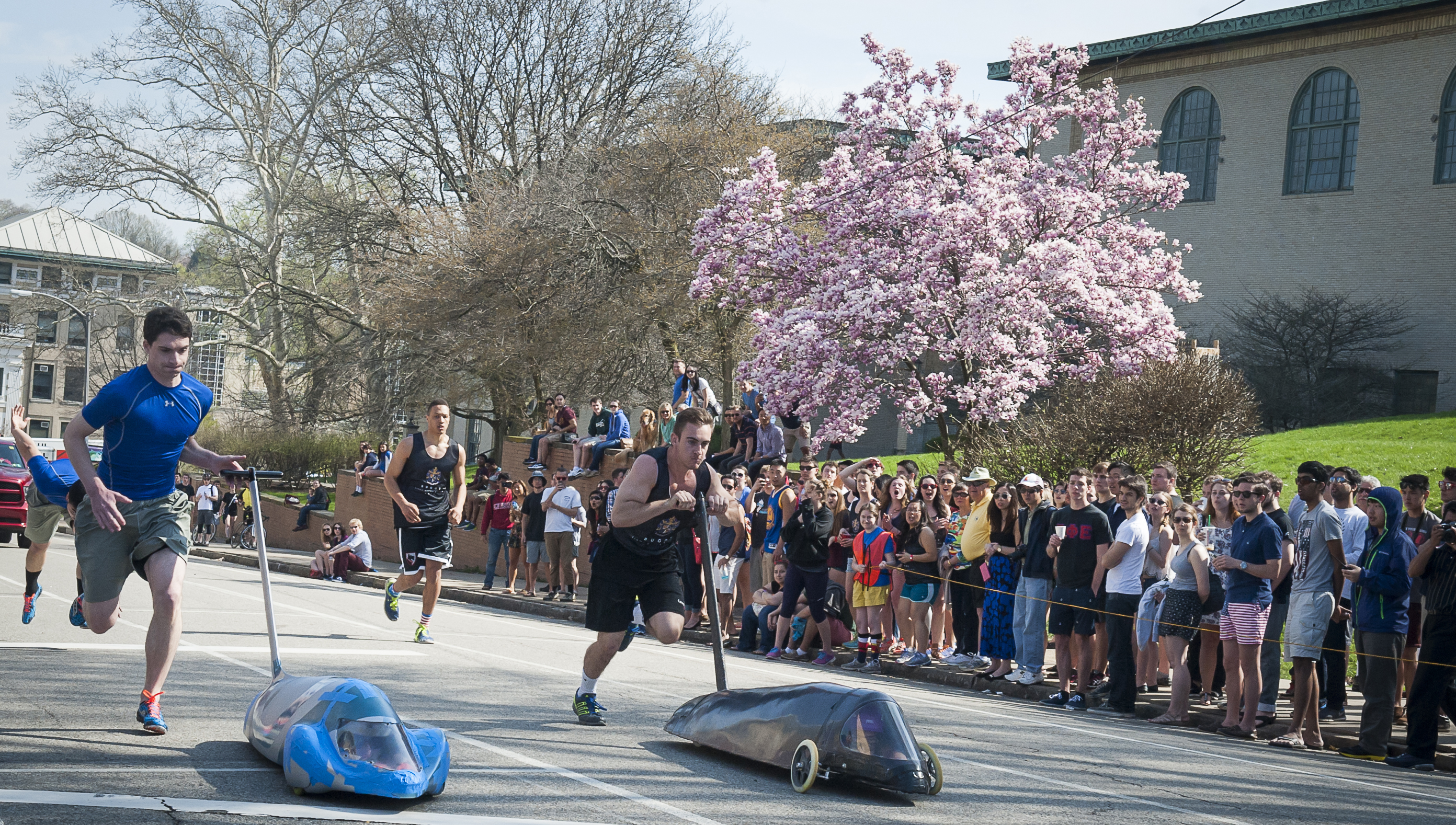 Students pushing buggys down a hill