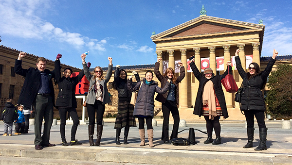 MAM students raising their arms