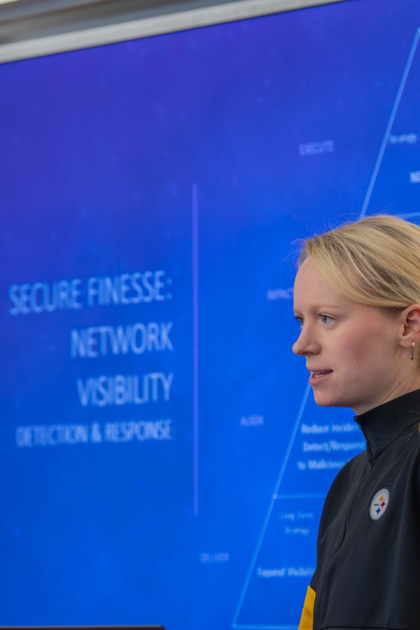 A photo of Carly Harris, a cybersecurity engineer at Nike and a Heinz College Information Security Policy and Management alumna, at an event at Heinz College.