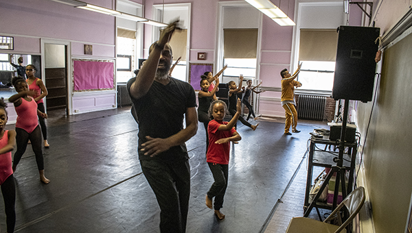 image of a dancer teaching a class to young girls