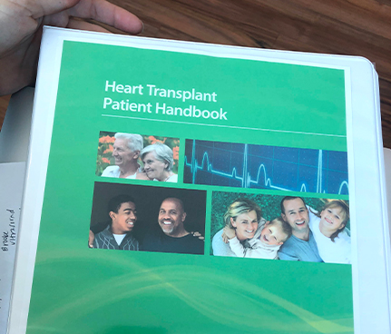 Jordan reviews the binder to list Tristan for a Heart Transplant. Photo courtesy of Jordan Mace.