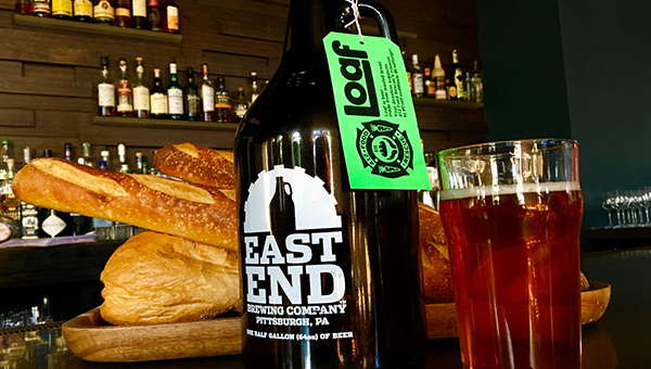 A growler full of LOAF beer made with salvaged bread