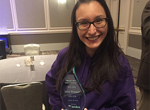 Jennifer Urgilez poses with the NCAC Cyber Challenge trophy