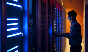 An IT professional working in a server room