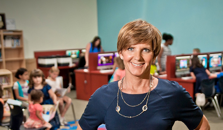 Susie Lee in a classroom of elementary students