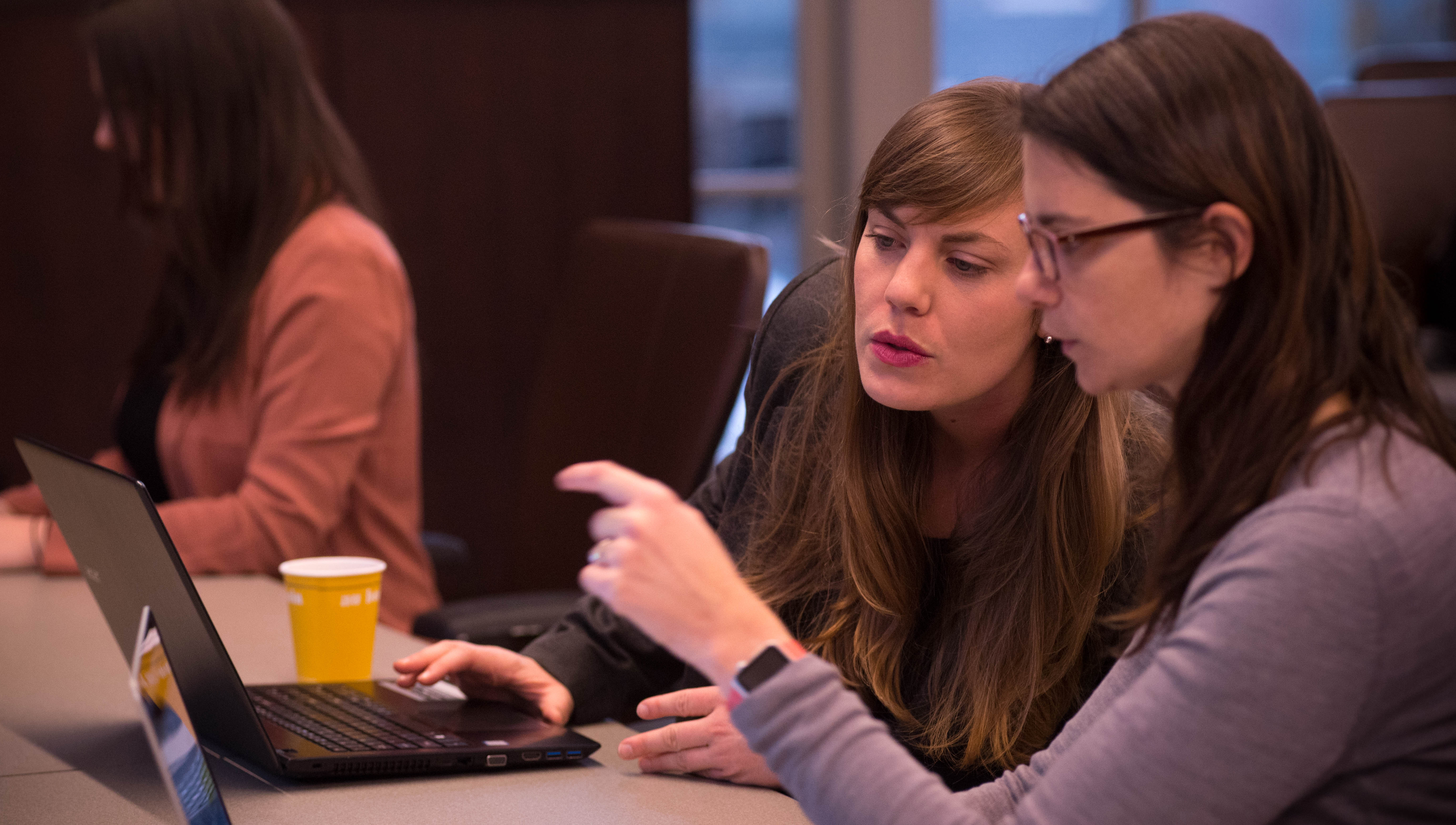 Students collaborating on the World Economic Forum capstone project at a conference table