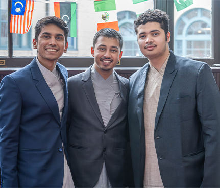 Three students gather in the Heinz College Rotunda.